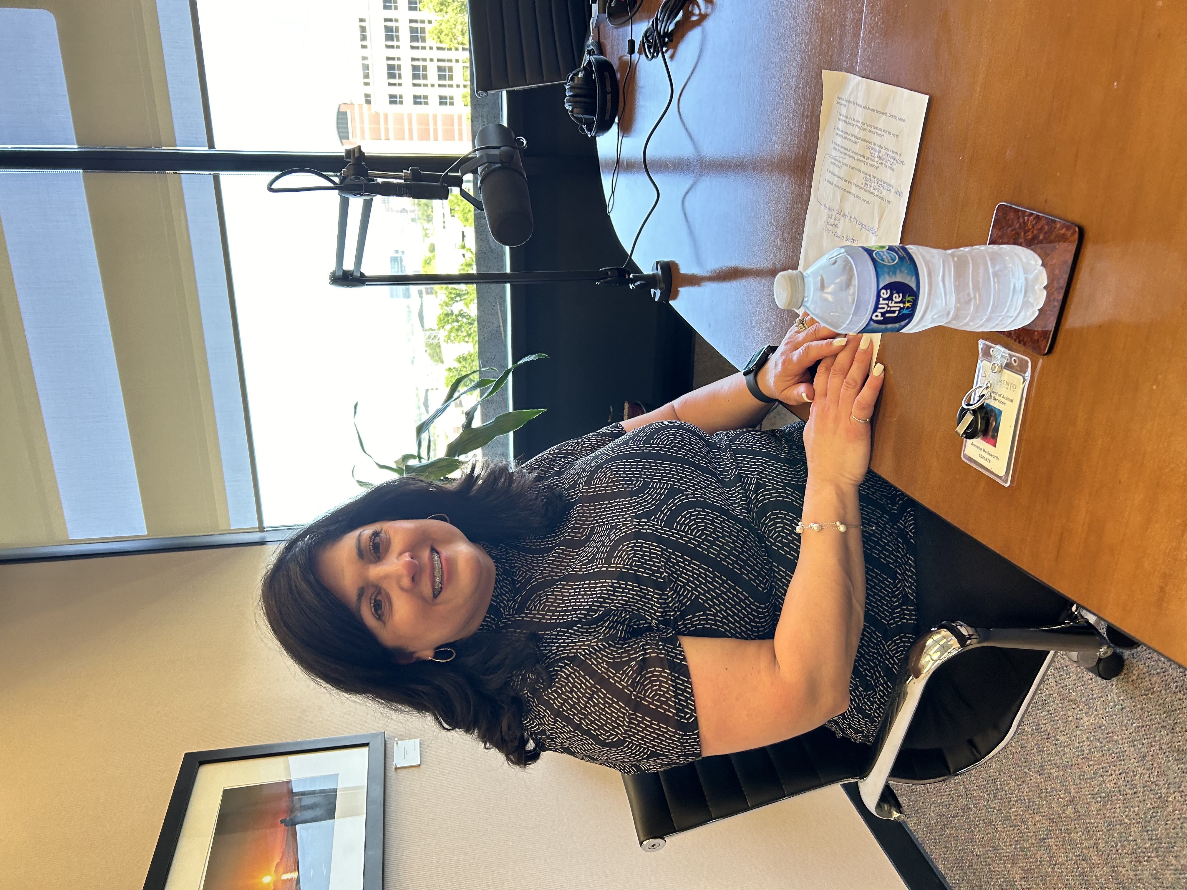 Annette Bedsworth sitting at a podcast table