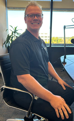 Chad Rinde, Fiance Director sitting at a podcast table