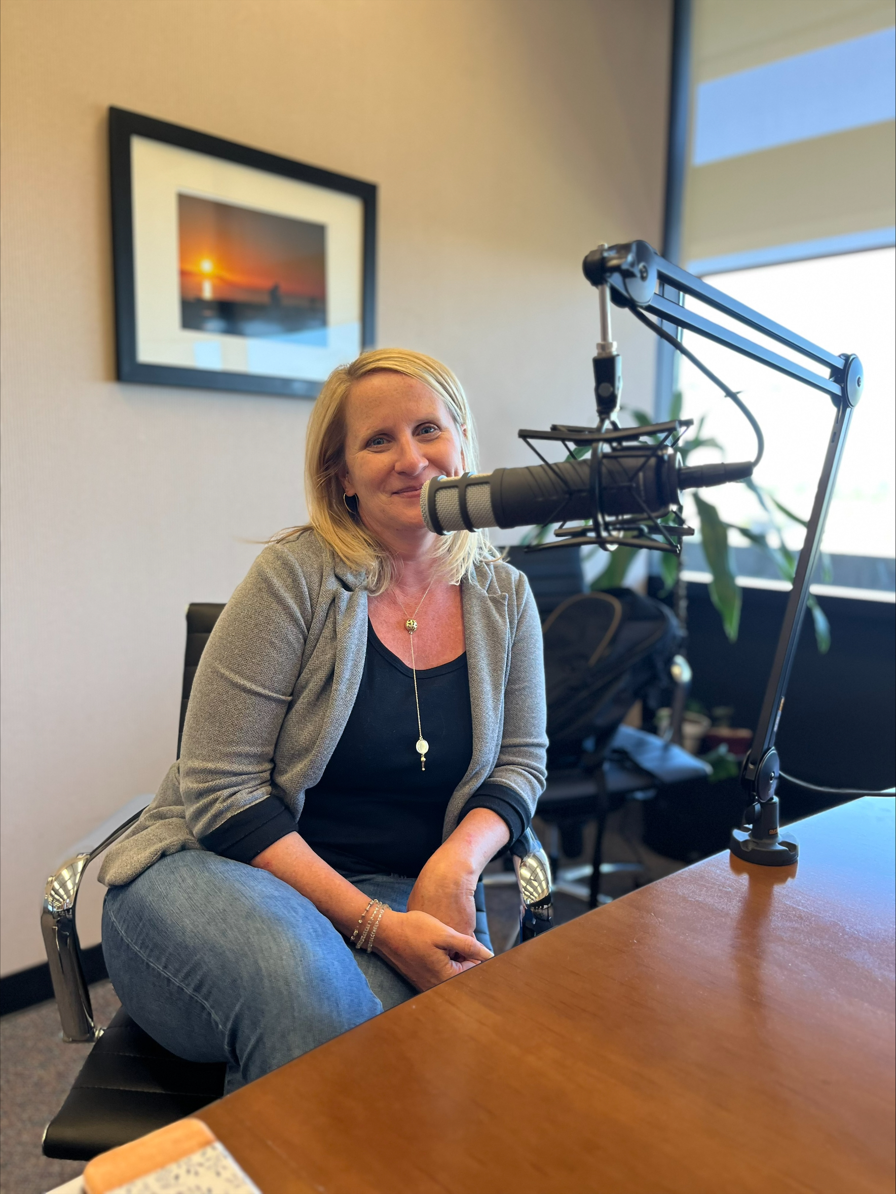 Emily Halcon sitting at a podcast table