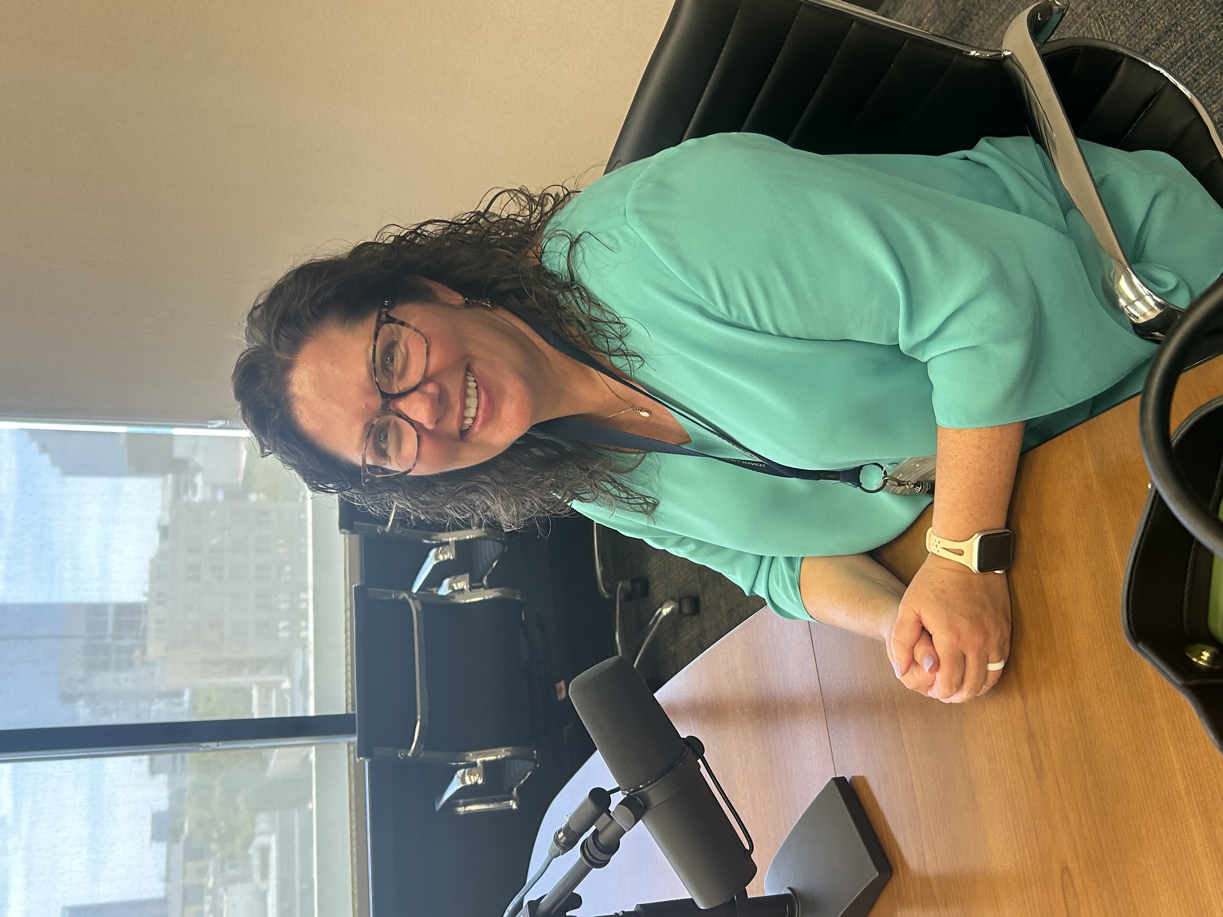 Mary Jo Flynn, Chief of Emergency Services for Sacramento County sitting at a podcast desk